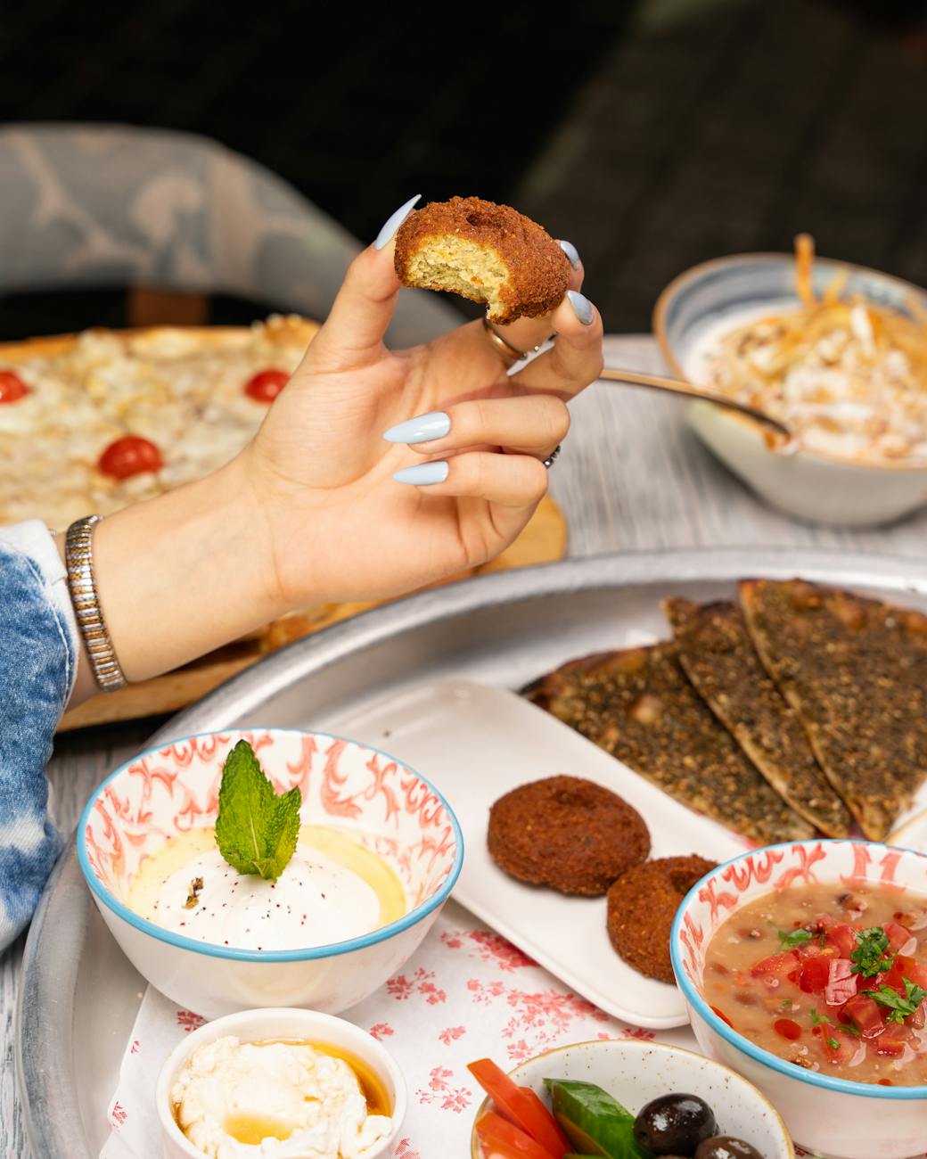 woman hand holding food over plate