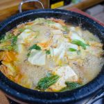 a close up shot of a boiling soup with vegetables