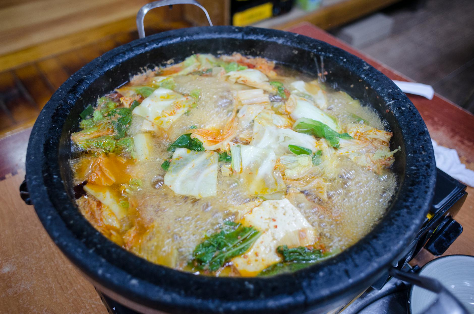 a close up shot of a boiling soup with vegetables