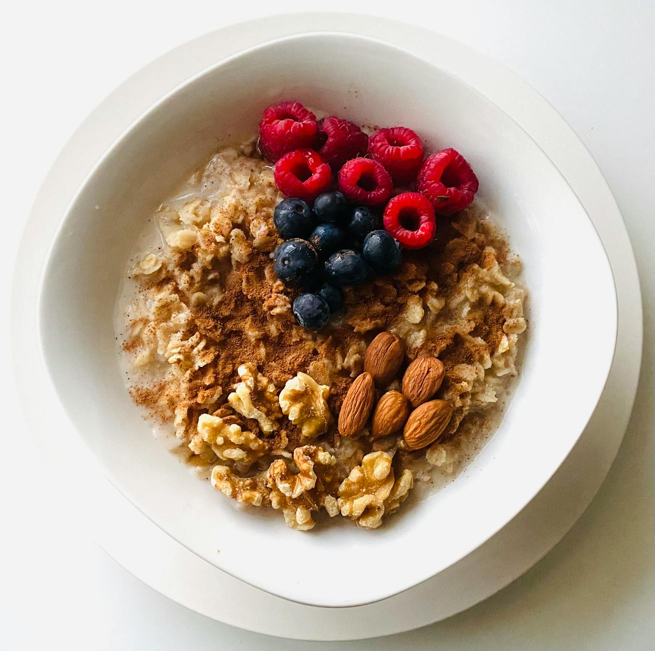 an oatmeal tops with nuts and fresh fruits